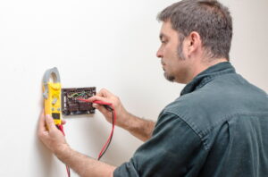 technician-repairing-a-thermostat