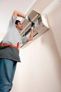 HVAC-technician-working-on-a-ductless-air-handler