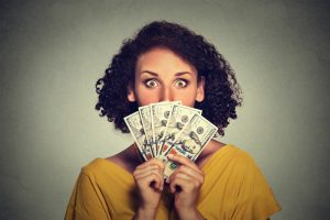 woman-holding-fanned-out-paper-money